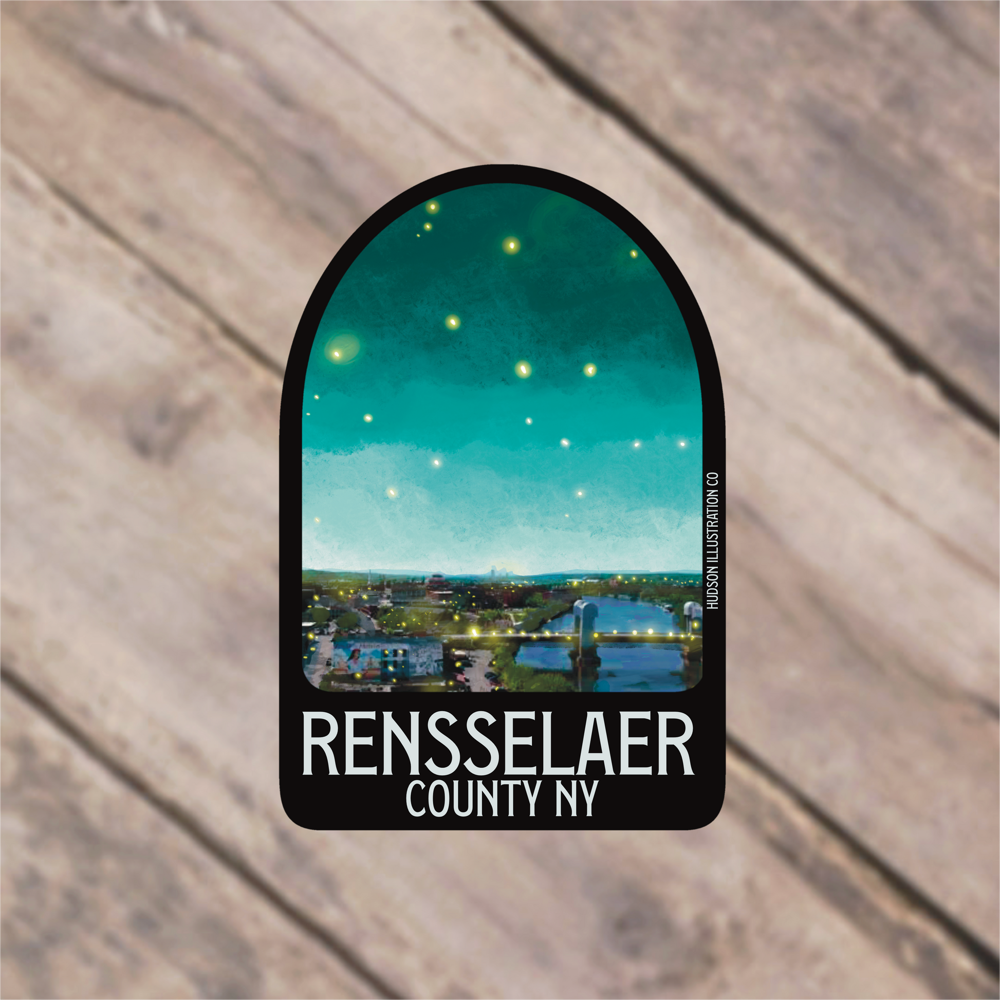 a sticker with a picture of a town in the background