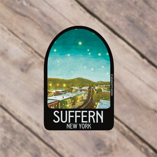 a sticker with a picture of a town in the background