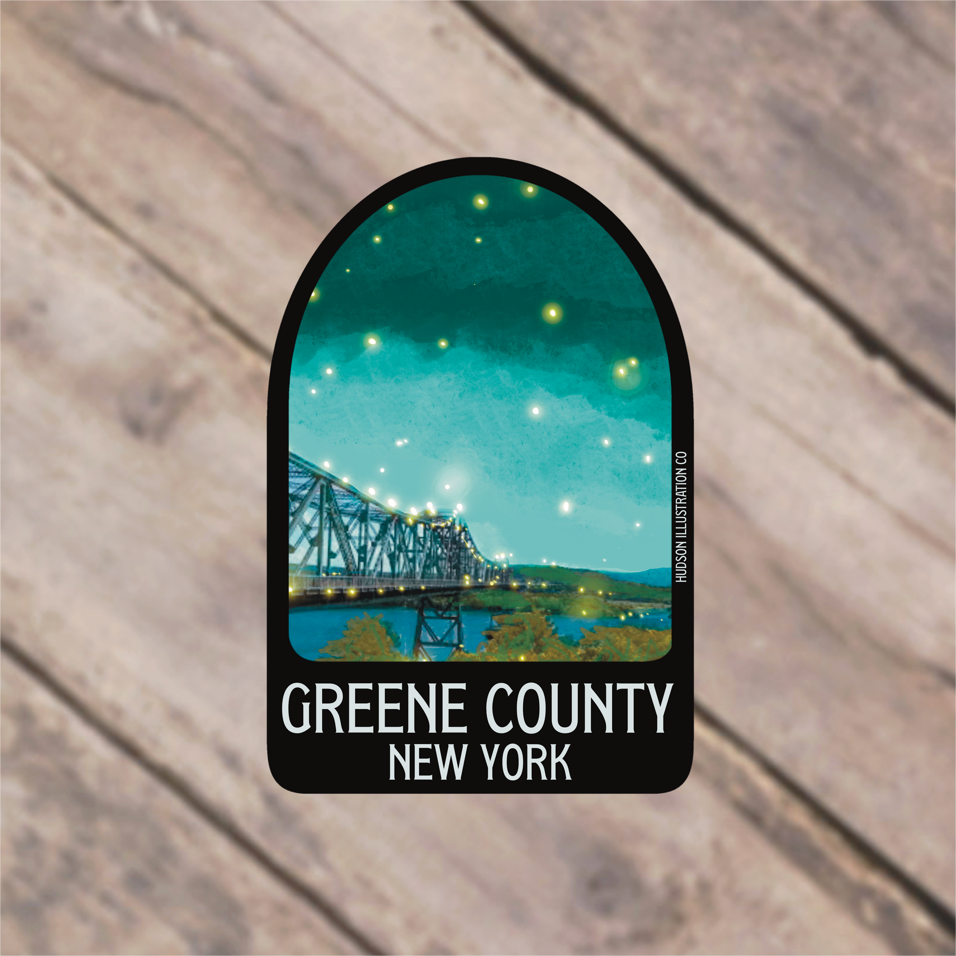 a sticker with a picture of a bridge in the background