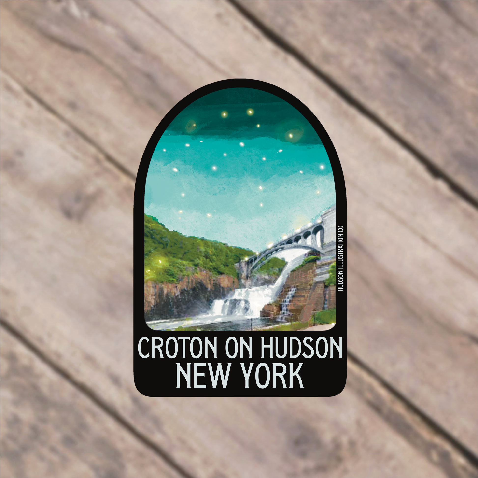 a sticker with a picture of a waterfall and a bridge