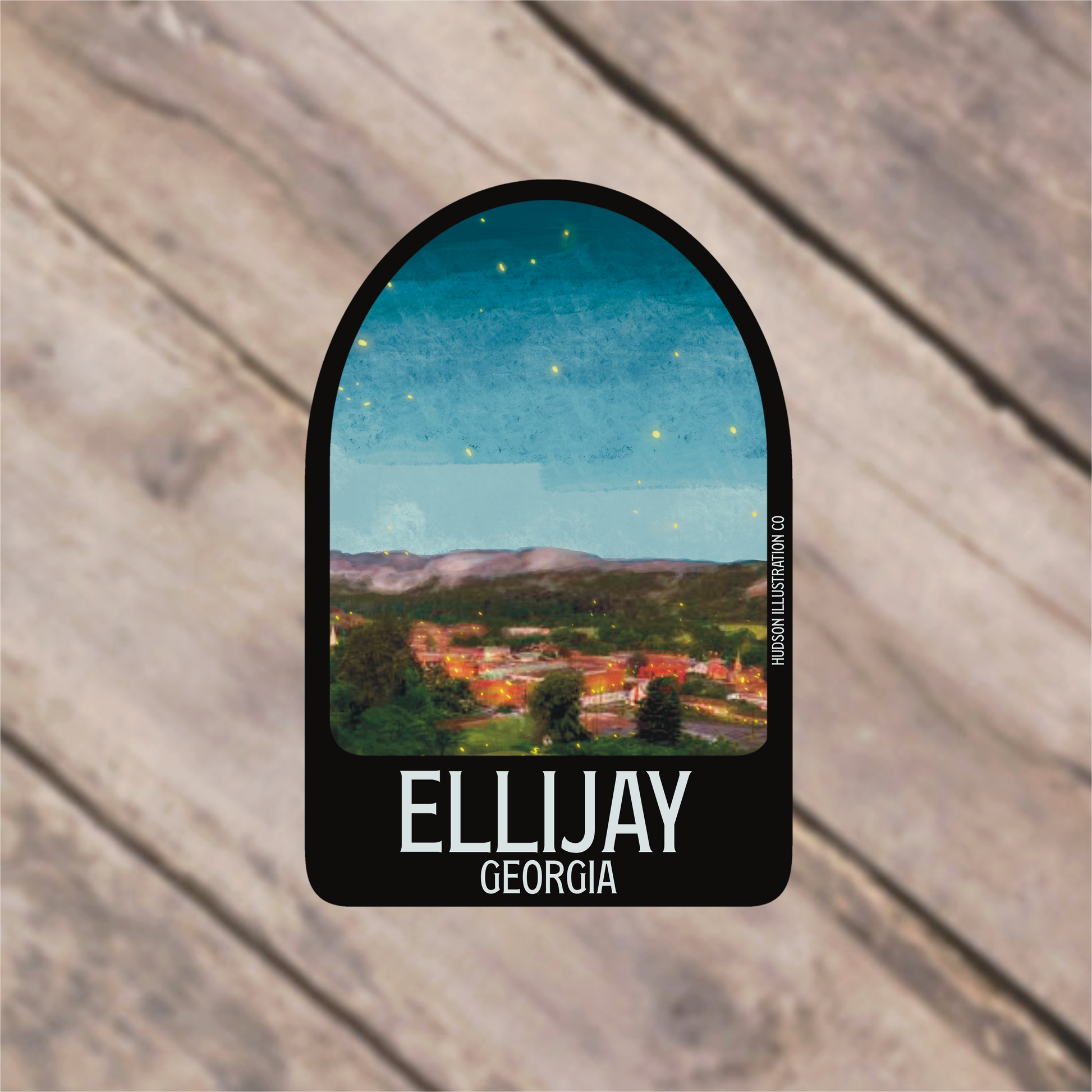 a sticker with a picture of a town in the background