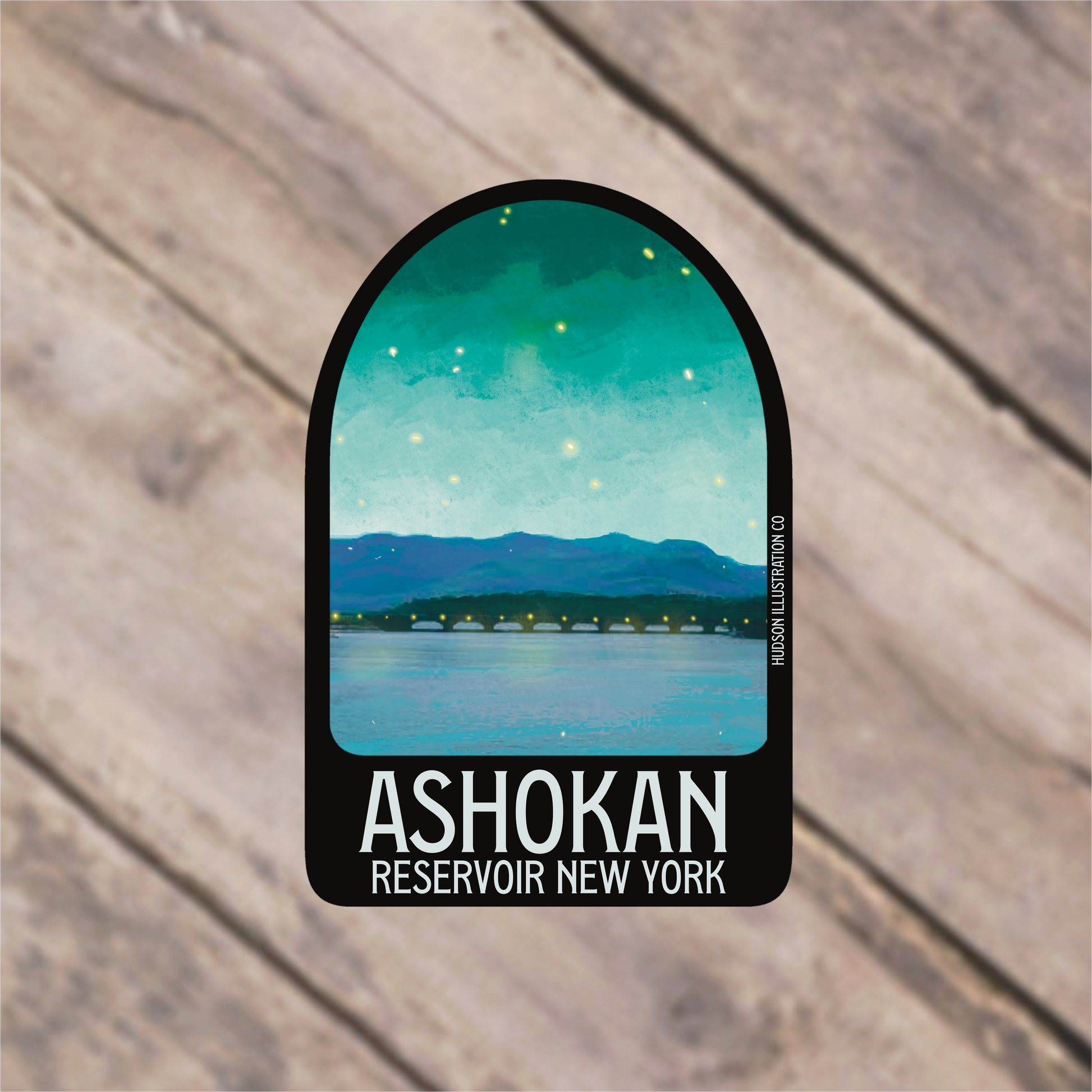 a sticker with a picture of a lake and mountains