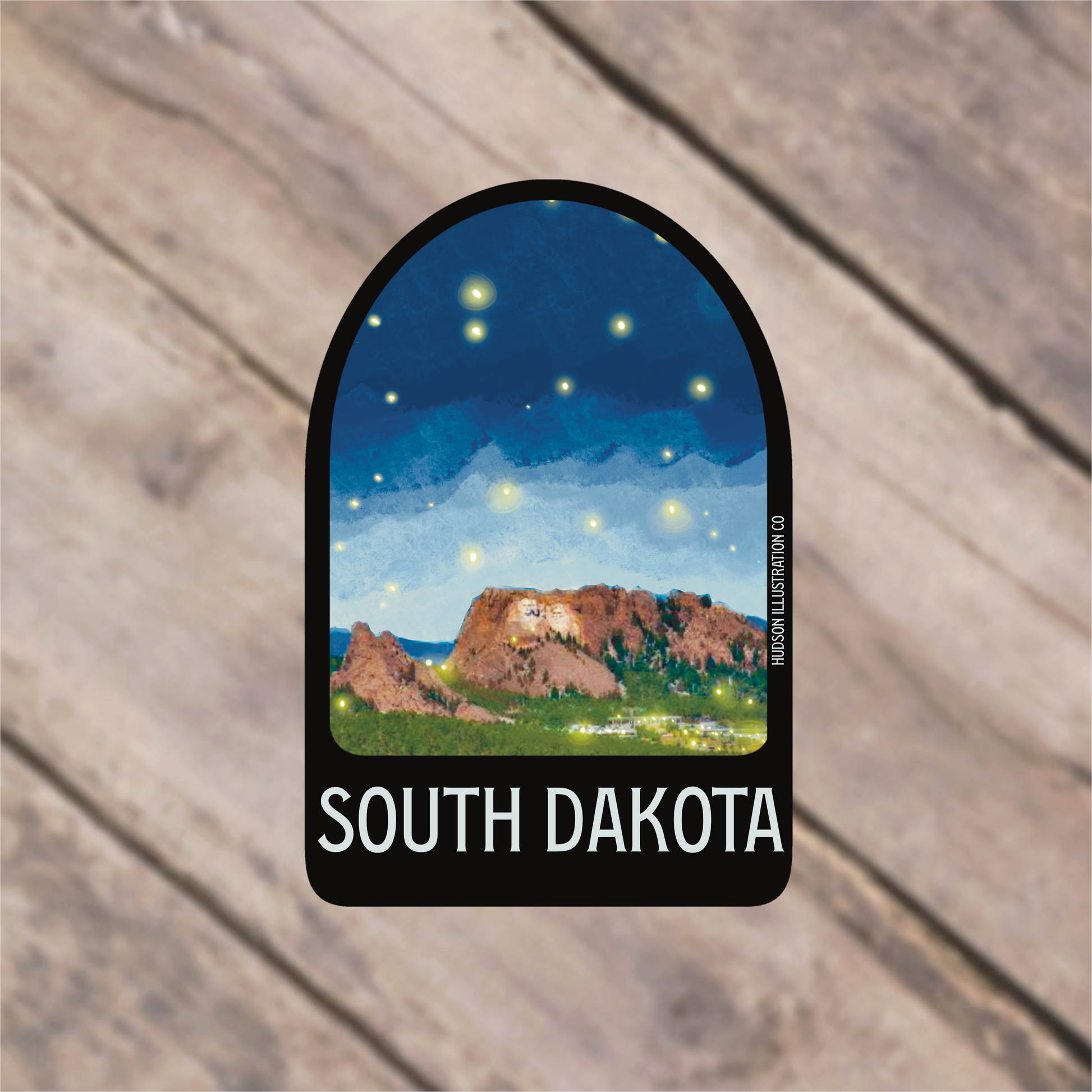 a sticker with a picture of a mountain and stars above it